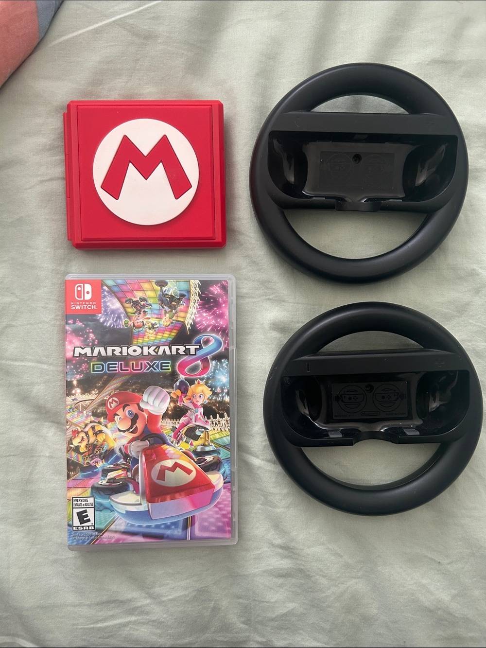 Nintendo Mario Kart 8 Deluxe bundle with wheels and game cartridge holder switch